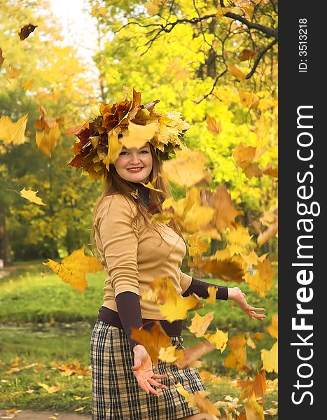 The cheerful girl on rest in autumn park