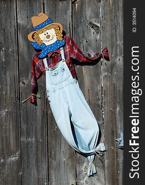 Scarecrow pinned to barn side. Scarecrow pinned to barn side