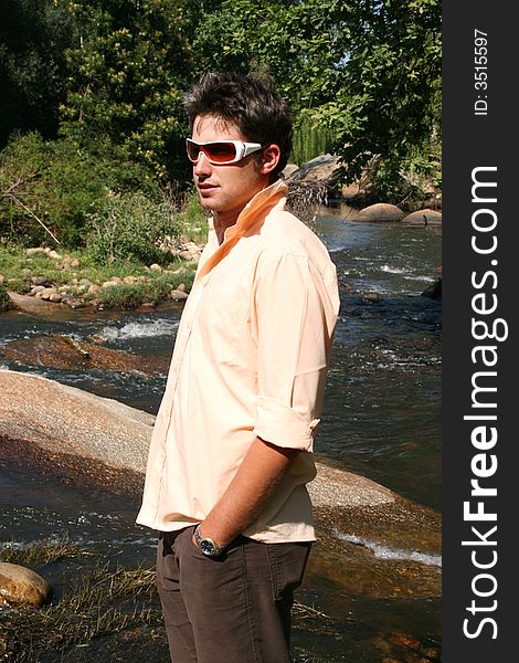 Young male model near the edge of the river. Young male model near the edge of the river
