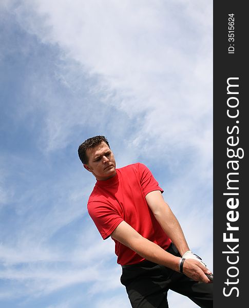 Young golfer at an angle preparing for a shot. Young golfer at an angle preparing for a shot