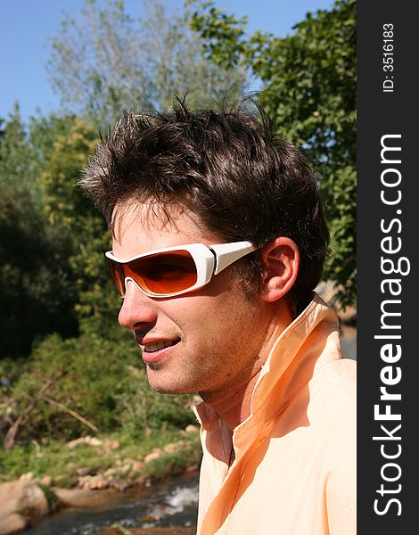 Close up of a young model, half profile with white sunglasses. Close up of a young model, half profile with white sunglasses