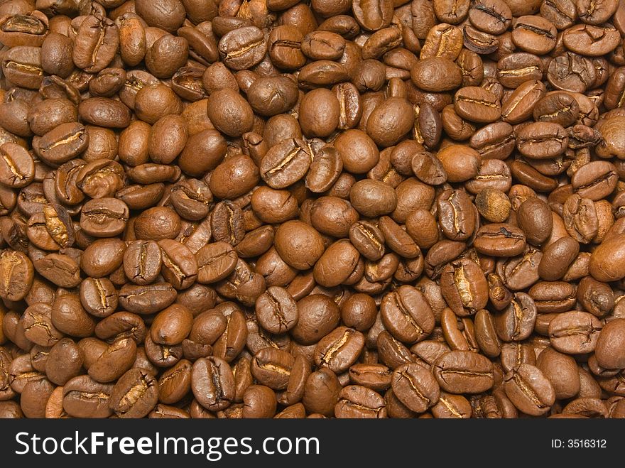 Coffee background of a host of big bright coffee beans