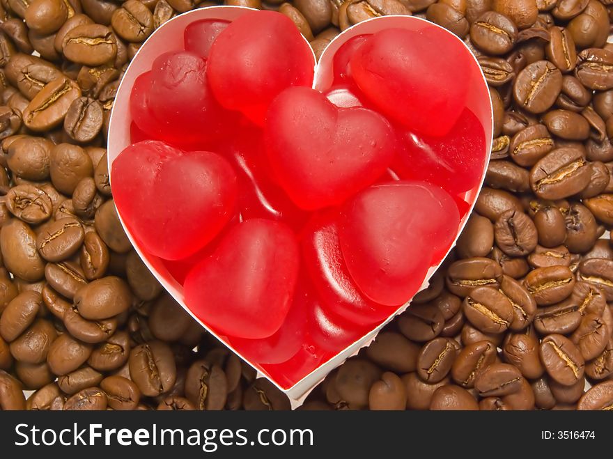 Red marmalade, in the form of hearts against the backdrop of coffee beans. Red marmalade, in the form of hearts against the backdrop of coffee beans