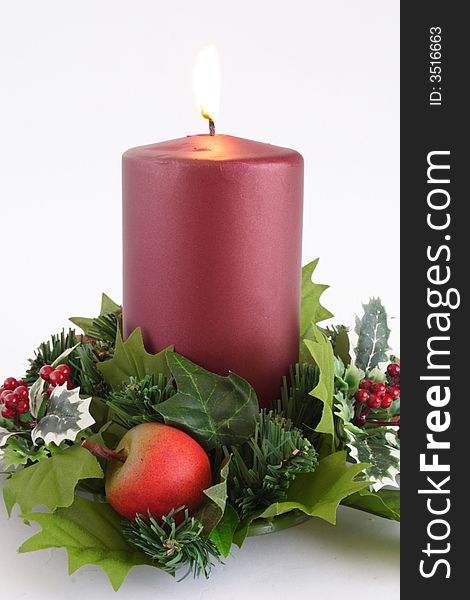 Lit red candle with Christmass decoration