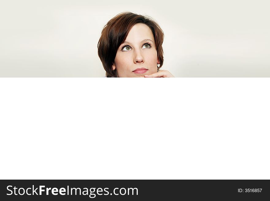 Close-up portrait of a beautiful woman. Looking up into the corner. Lots of copyspace and room for text on this isolate. Close-up portrait of a beautiful woman. Looking up into the corner. Lots of copyspace and room for text on this isolate.