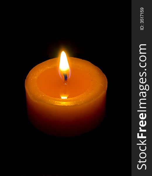 Closeup of a candle with black background.