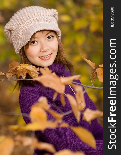 A girl posing in woods with faded leaves. A girl posing in woods with faded leaves