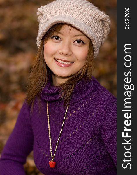 A smiling girl in deep fall woods