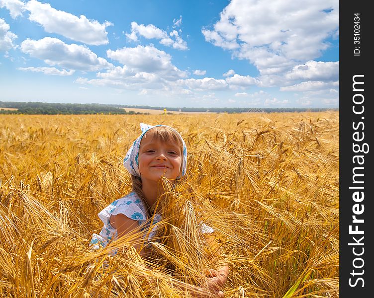 Beautiful happy little girl in a meadow summer time. Beautiful happy little girl in a meadow summer time