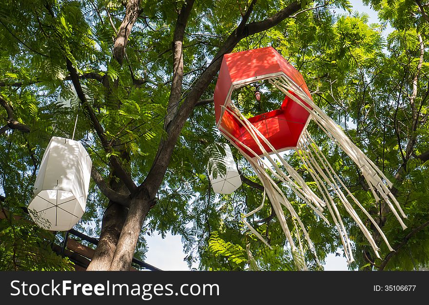 Red paper Japanese lantern hang on the tree. The lantern is in the wind that blows slowly. Red paper Japanese lantern hang on the tree. The lantern is in the wind that blows slowly