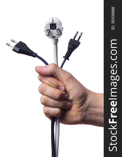 Human hand holding 3 cables with power plugs, 2 black, 1 white, hand is a fist, isolated background. Human hand holding 3 cables with power plugs, 2 black, 1 white, hand is a fist, isolated background