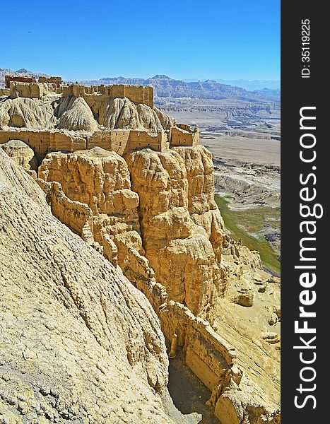 Tibet.Rocks in the valley of the river Sutlej.On the cliff is the palace of the Sun. Tibet.Rocks in the valley of the river Sutlej.On the cliff is the palace of the Sun