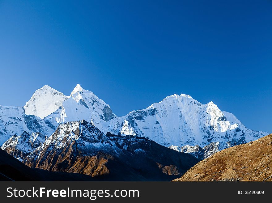 Mount Ama Dablam in Himalaya Mountains, Nepal. Beautiful Himalayan landscape on sunny autumn day. Mount Ama Dablam in Himalaya Mountains, Nepal. Beautiful Himalayan landscape on sunny autumn day.
