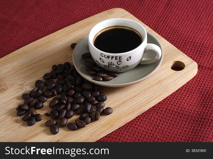 A Cup of robusta Coffee at and Coffee Beans wooden board