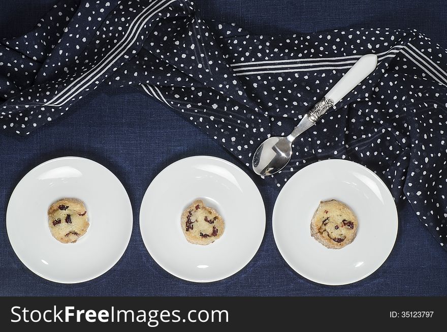 Porcelain dishes and cookies with cranberries. From series Playing with Color