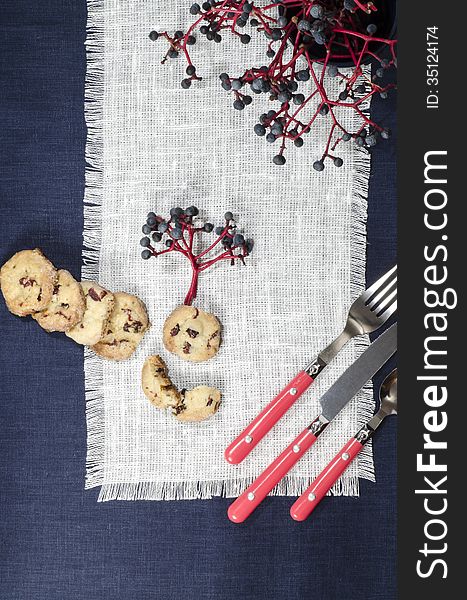 Porcelain dishes and cookies with cranberries. From series Playing with Color