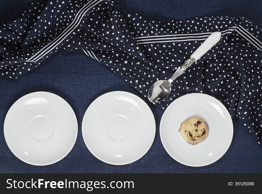 Porcelain dishes and cookies with cranberries. From series Playing with Color