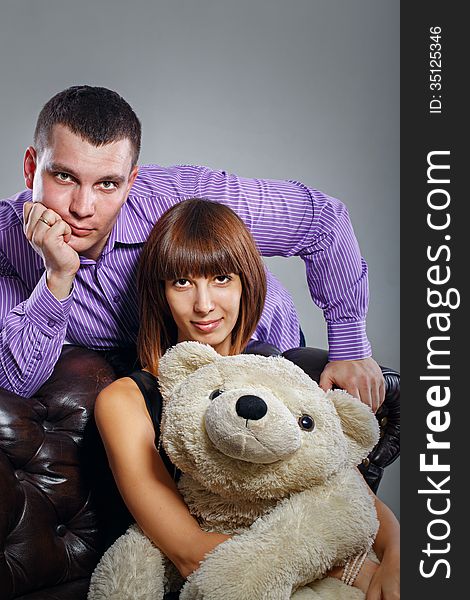 Attractive couple guy, a girl and a teddy bear. Attractive couple guy, a girl and a teddy bear