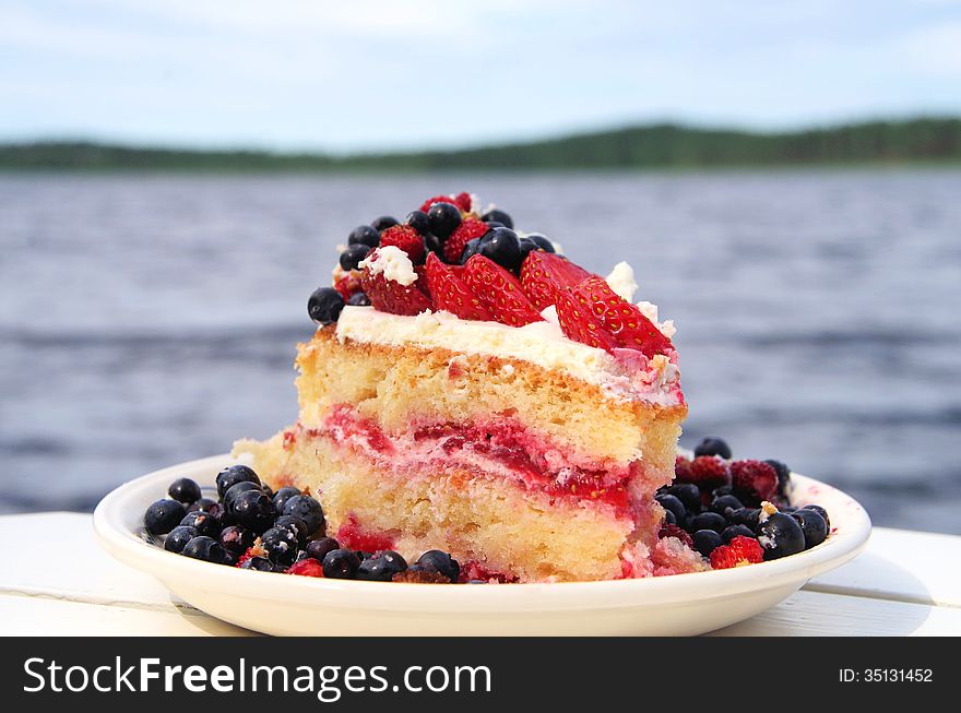A summery cream cake with fresh berries. A summery cream cake with fresh berries