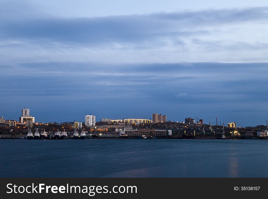 The night city at the sea is shone with fires of lamps and buildings