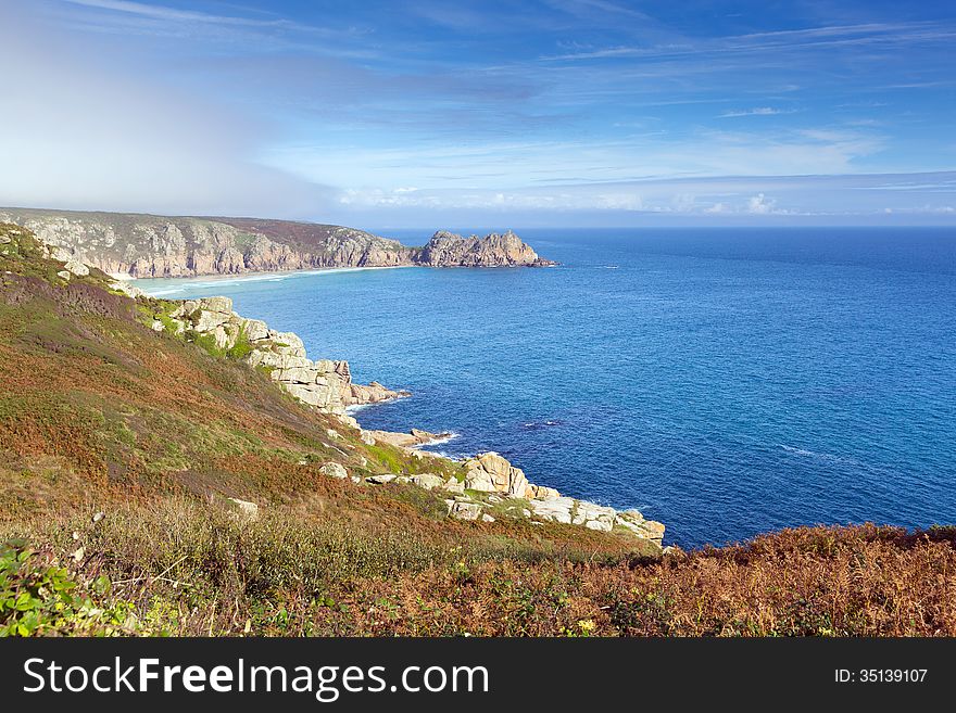 Coast of Cornwall England in autumn with mist and blue sky