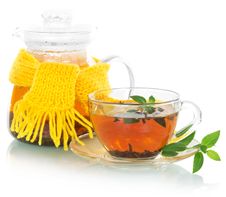 Tea With Mint, Teapot In A Yellow Scarf Royalty Free Stock Photo