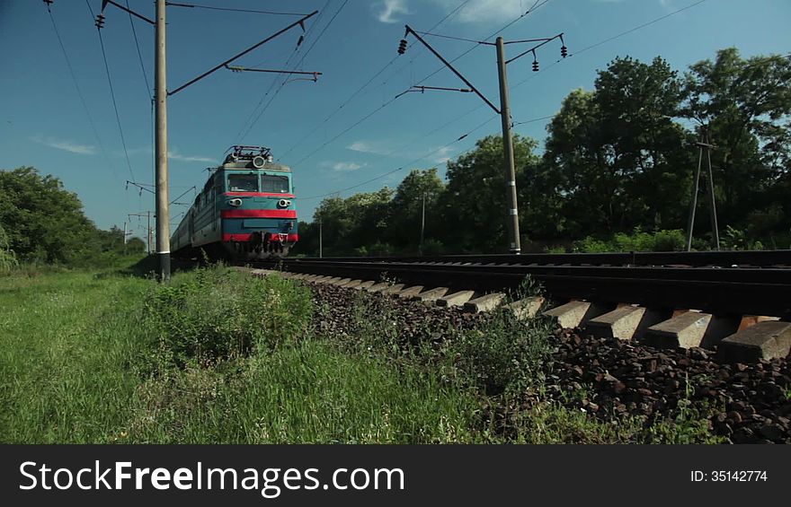 Sunny day. Countryside. Passenger train approaching and passing by. Sunny day. Countryside. Passenger train approaching and passing by