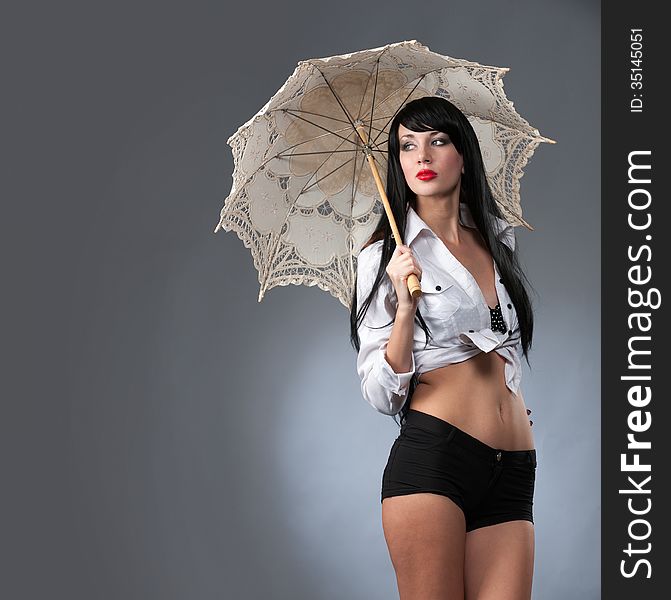 Young beautiful woman holding a bright umbrella. Young beautiful woman holding a bright umbrella