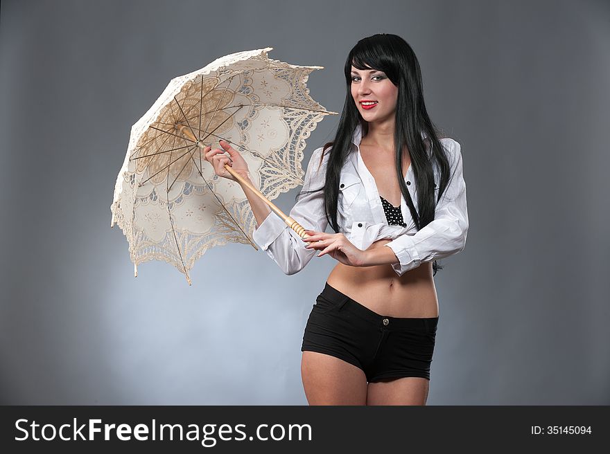 Young beautiful woman holding a bright umbrella. Young beautiful woman holding a bright umbrella