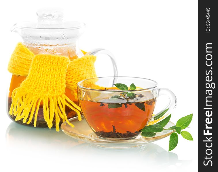 Tea with mint, a teapot in a yellow scarf on a white background. Tea with mint, a teapot in a yellow scarf on a white background