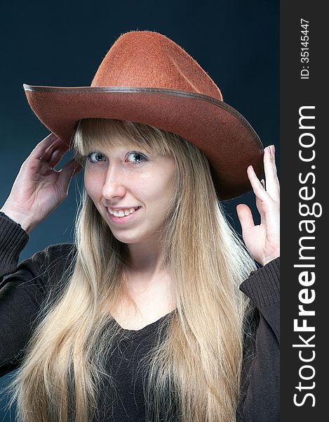 Portrait of a young blonde in a cowboy hat. Portrait of a young blonde in a cowboy hat