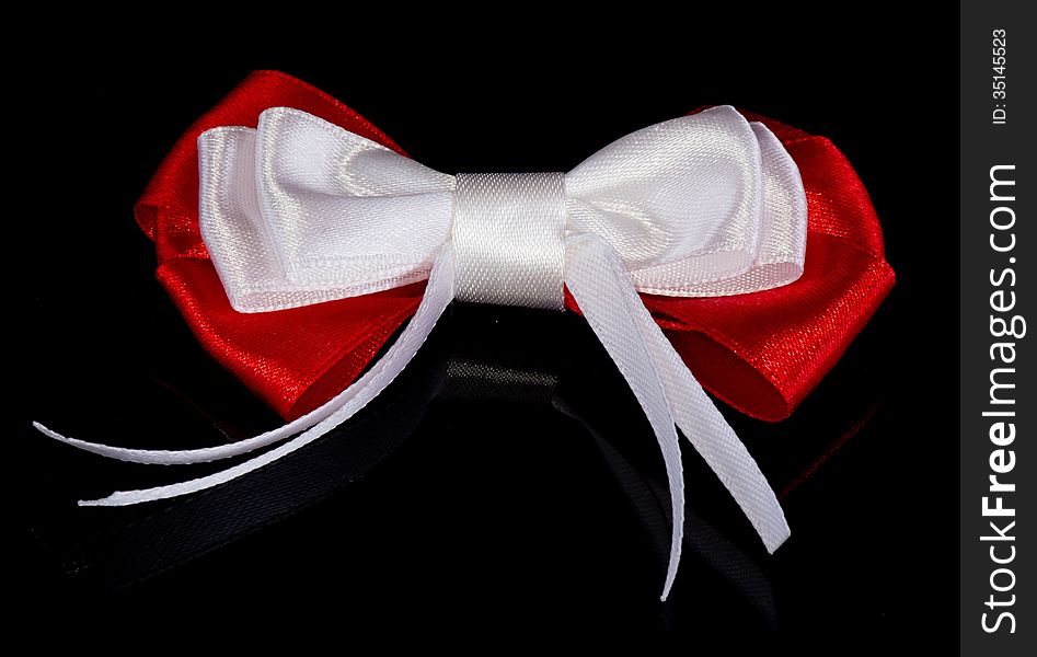 Red-white bow isolated on the black