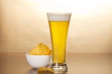 Glass Of Light Amber Beer And Bowl With Chips Stock Images