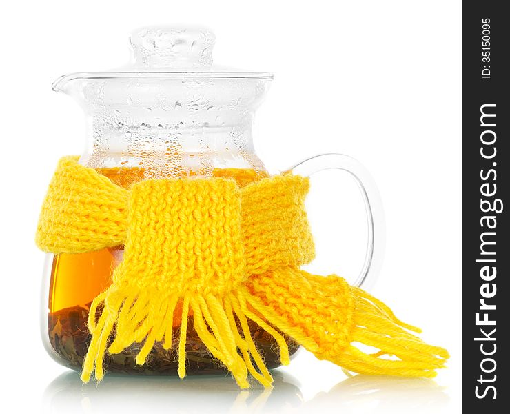 Teapot with tea tied with a yellow scarf on the white. Teapot with tea tied with a yellow scarf on the white
