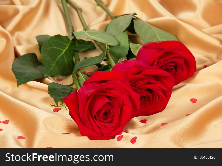 Romantic red roses on gold textile