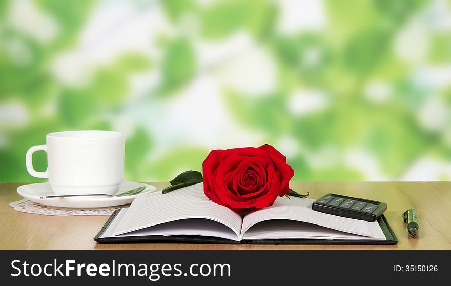 Coffee, notebook, red rose on a little table in cafe. Coffee, notebook, red rose on a little table in cafe