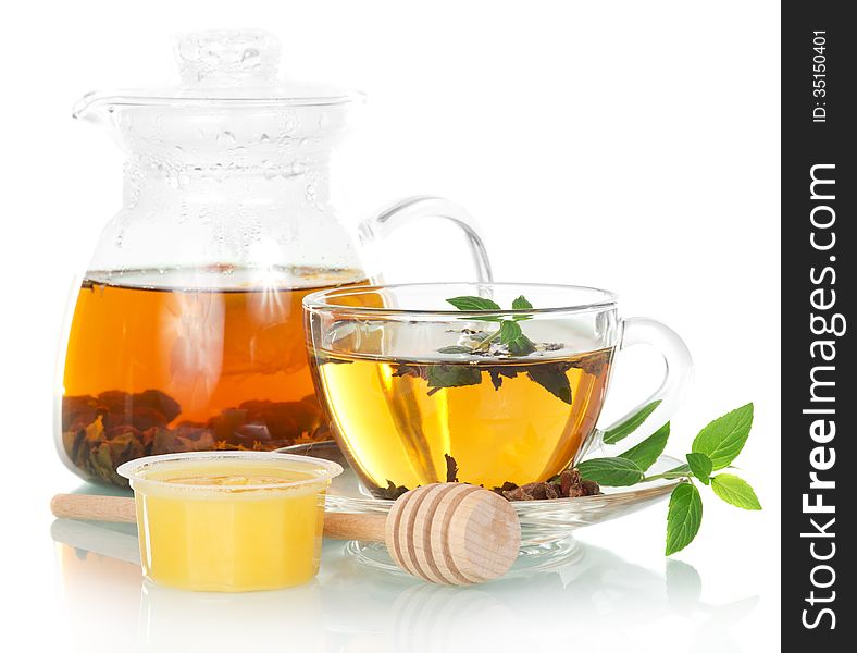 Teapot with mint tea and honey on a white background