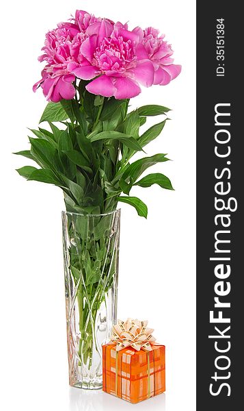 Flowers in a vase and the gift box decorated with a bow, isolated on white