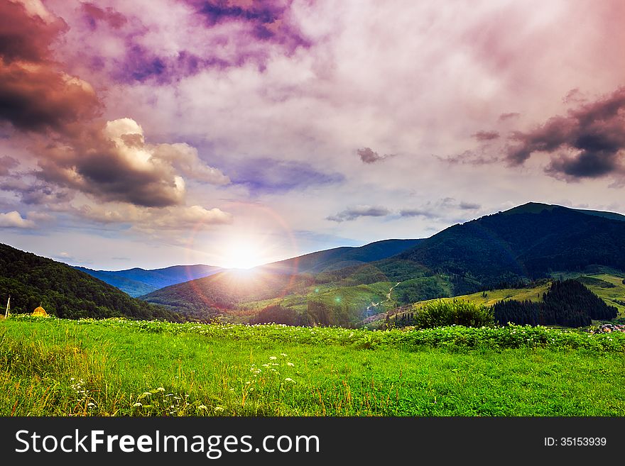 Valley near forest on a steep mountain slope after the rain in evening mood