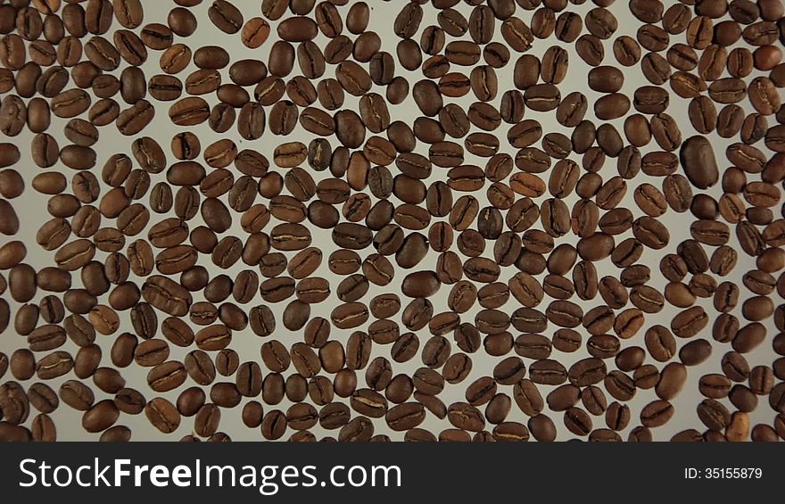 Whole grains are roasted coffee. Man's finger paints the symbol of coffee. Whole grains are roasted coffee. Man's finger paints the symbol of coffee