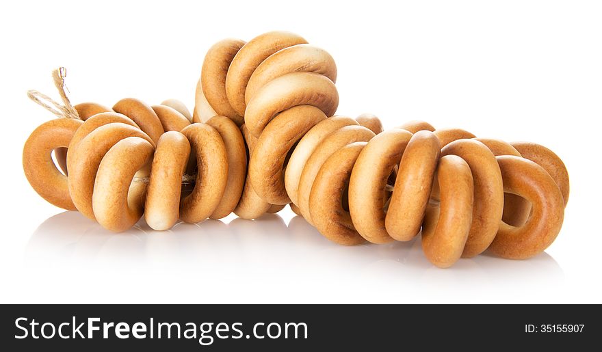 Tasty bagels on rope, isolated on white
