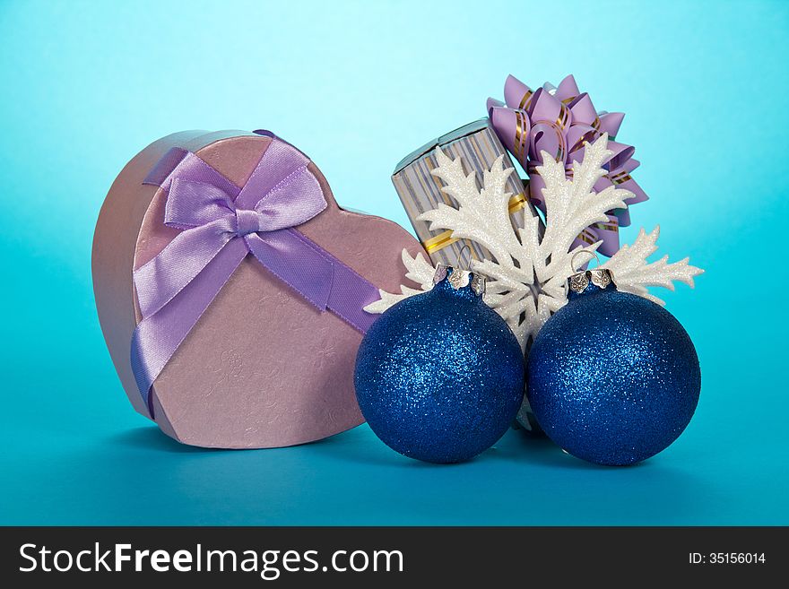 Two gift boxes, Christmas toys and snowflake on a blue background