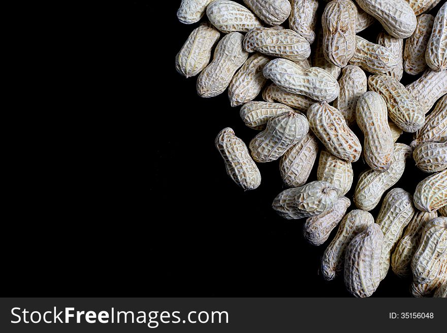 Spill Peanuts on black background