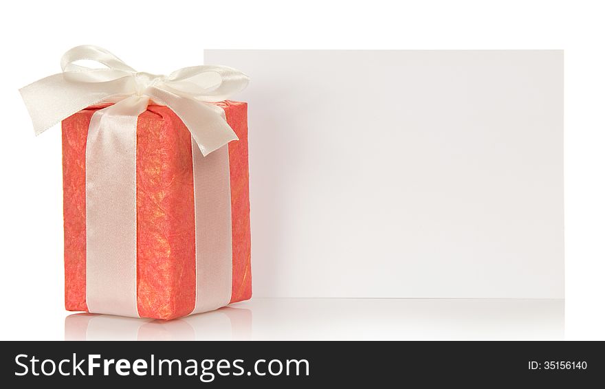 Beautiful gift box with a ribbon and bow, empty card for the message isolated on white. Beautiful gift box with a ribbon and bow, empty card for the message isolated on white