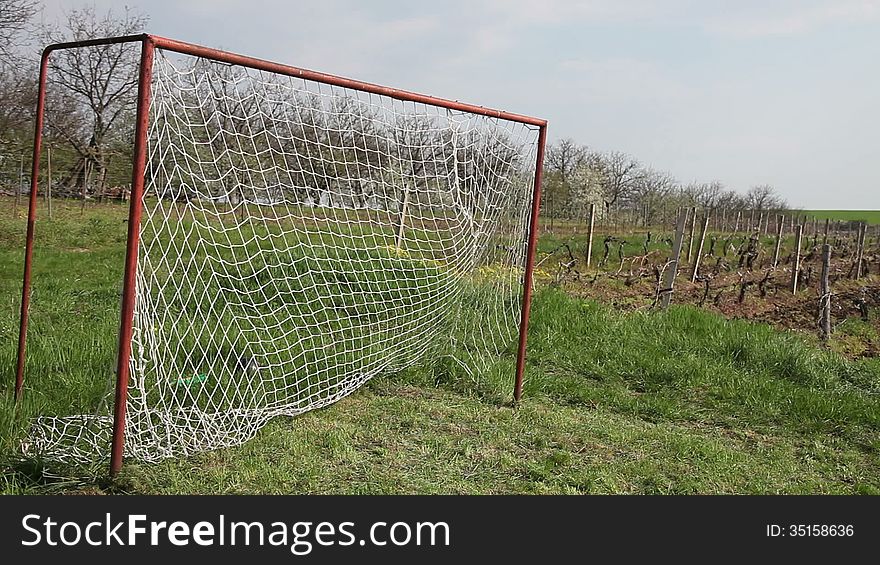 Soccer ball flies into old goal hitting net,nature. Soccer ball flies into old goal hitting net,nature