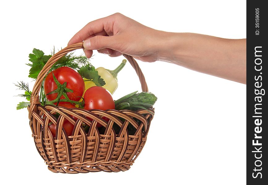 The female hand holds a basket with the vegetables, isolated on white. The female hand holds a basket with the vegetables, isolated on white