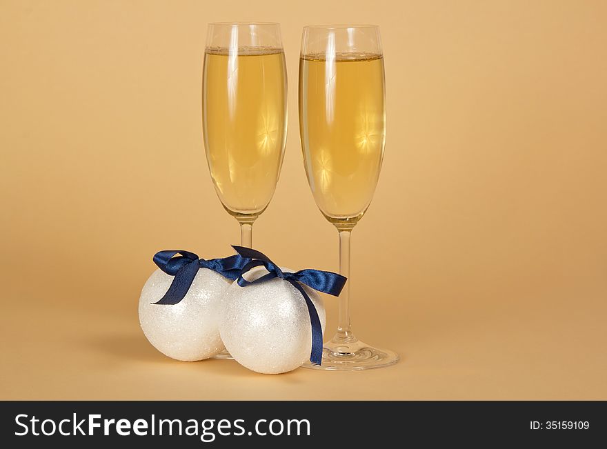 Wine glasses with champagne and New Year s spheres