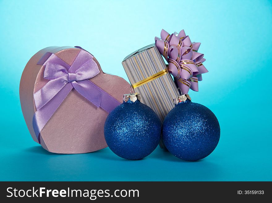 Two gift boxes and Christmas toys on a blue background