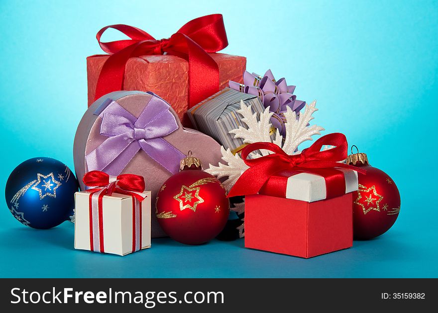 Various gift boxes and beautiful Christmas toys on a blue background