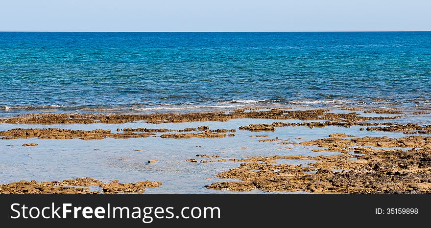 Coastal landscape with sea water and rocks.